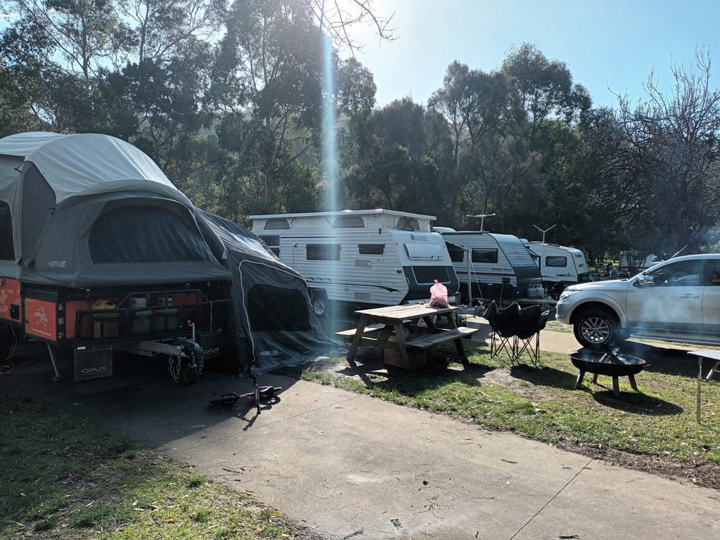 family camping setup with camper trailer