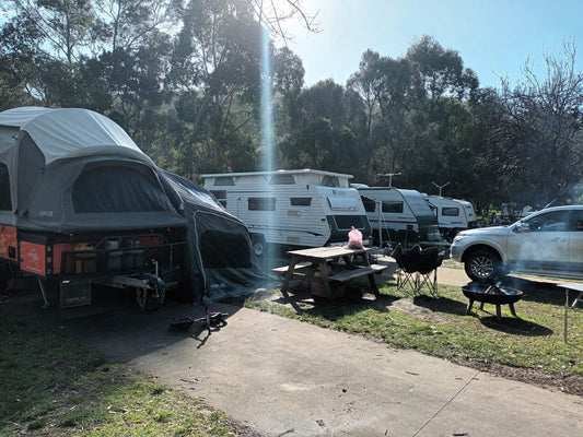family camping setup with camper trailer