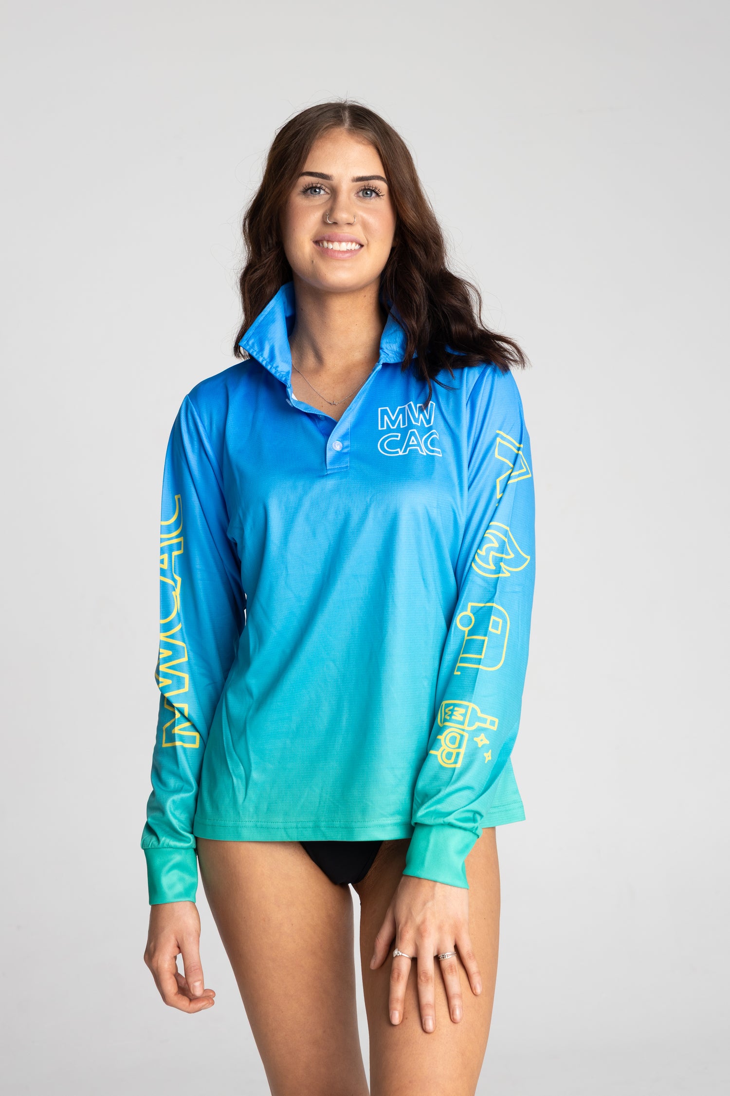 Woman wearing a blue long-sleeve shirt with yellow text on a gray background