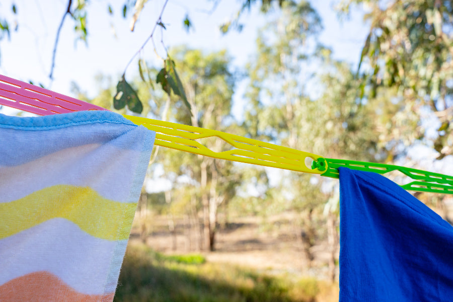 Camping clothesline slides holding washing outdoors