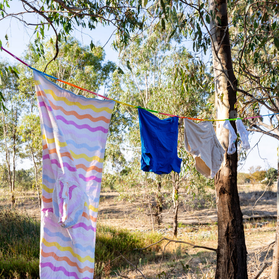 Washing drying in the sun on the pegless camping clothesline