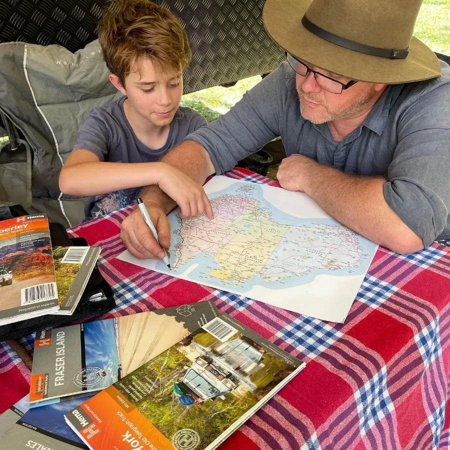 Marking off travelled towns on the Map of Australia sticker with a marker
